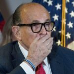 Disgraced ex-Trump lawyer Rudy Giuliani falls from his chair at RNC