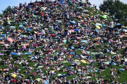 Fans swarm over hills in Munich, claiming a high spot for watching Taylor Swift's concert