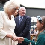 Queen Camilla visits Wimbledon and does 'the wave' with fans