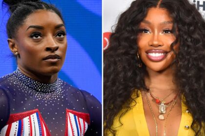 SZA shows off gymnastics skills in a friendly handstand competition with Simone Biles