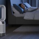 Dyson Hot+Cool Gen1 in a bedroom, next to a sleeping woman