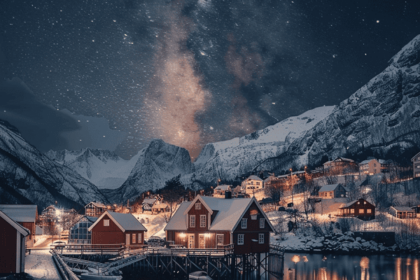 Night in a wintery landscape with red houses in the background.