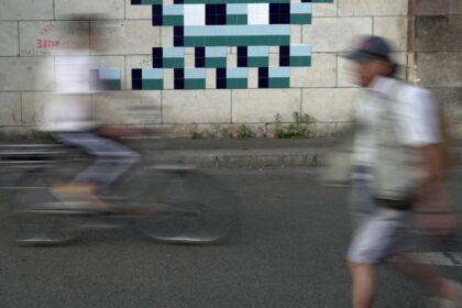 Mysterious Parisian street artist 'Invader' stitches together new work to celebrate the Olympic Games and surprise fans