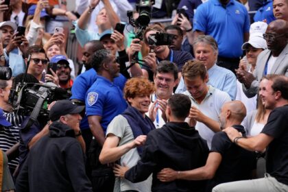 Jannik Sinner gets a hug from his friend Seal after winning the US Open title