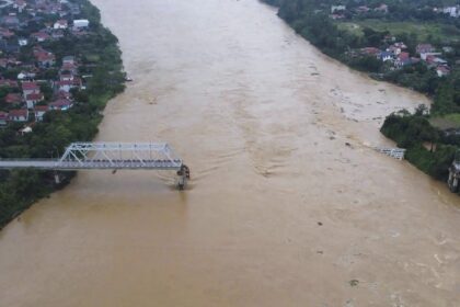 The number of deaths from the storm in Vietnam rises to 64 as a bridge collapses and a bus is swept away by floods